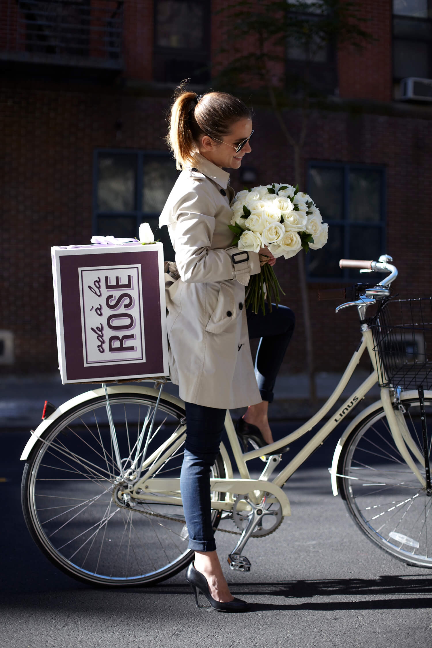 Woman on a bike with flowers