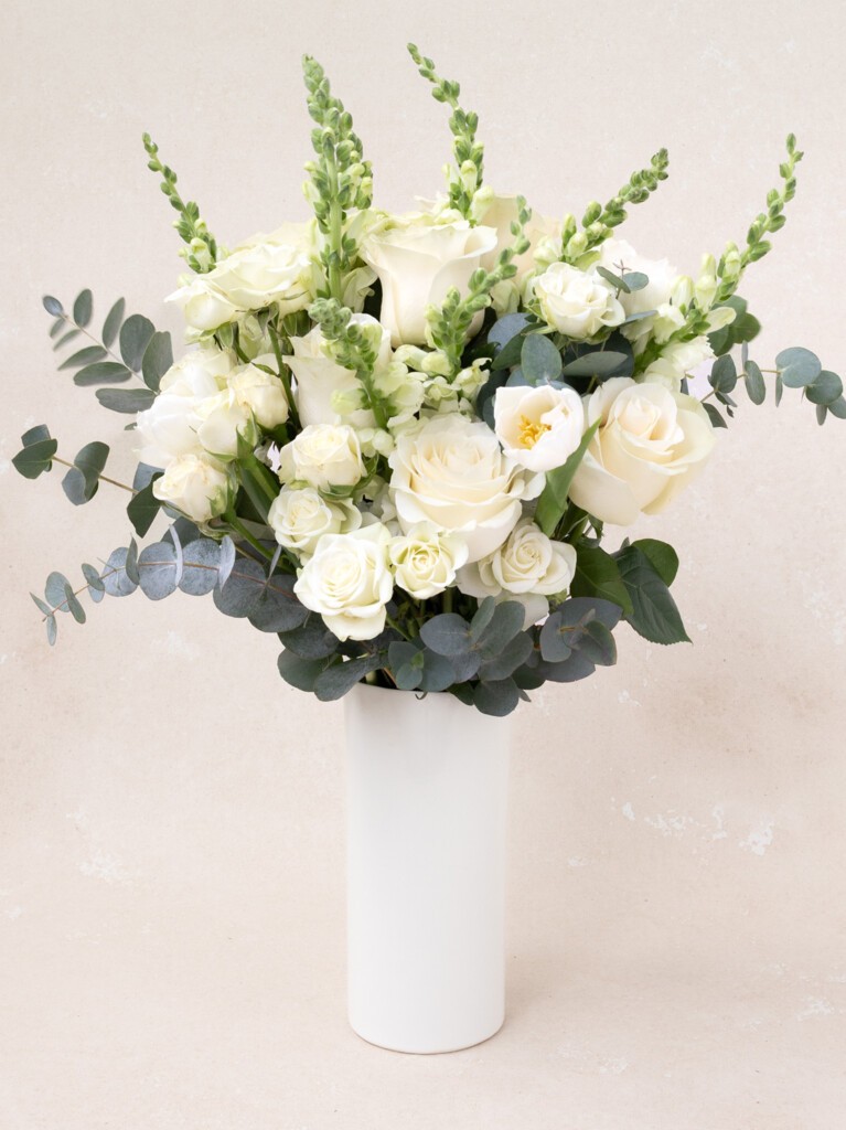 Elegant Paulette bouquet with 26 premium white stems, including roses, snapdragons, and tulips, designed for weddings, anniversaries, or refined home styling.